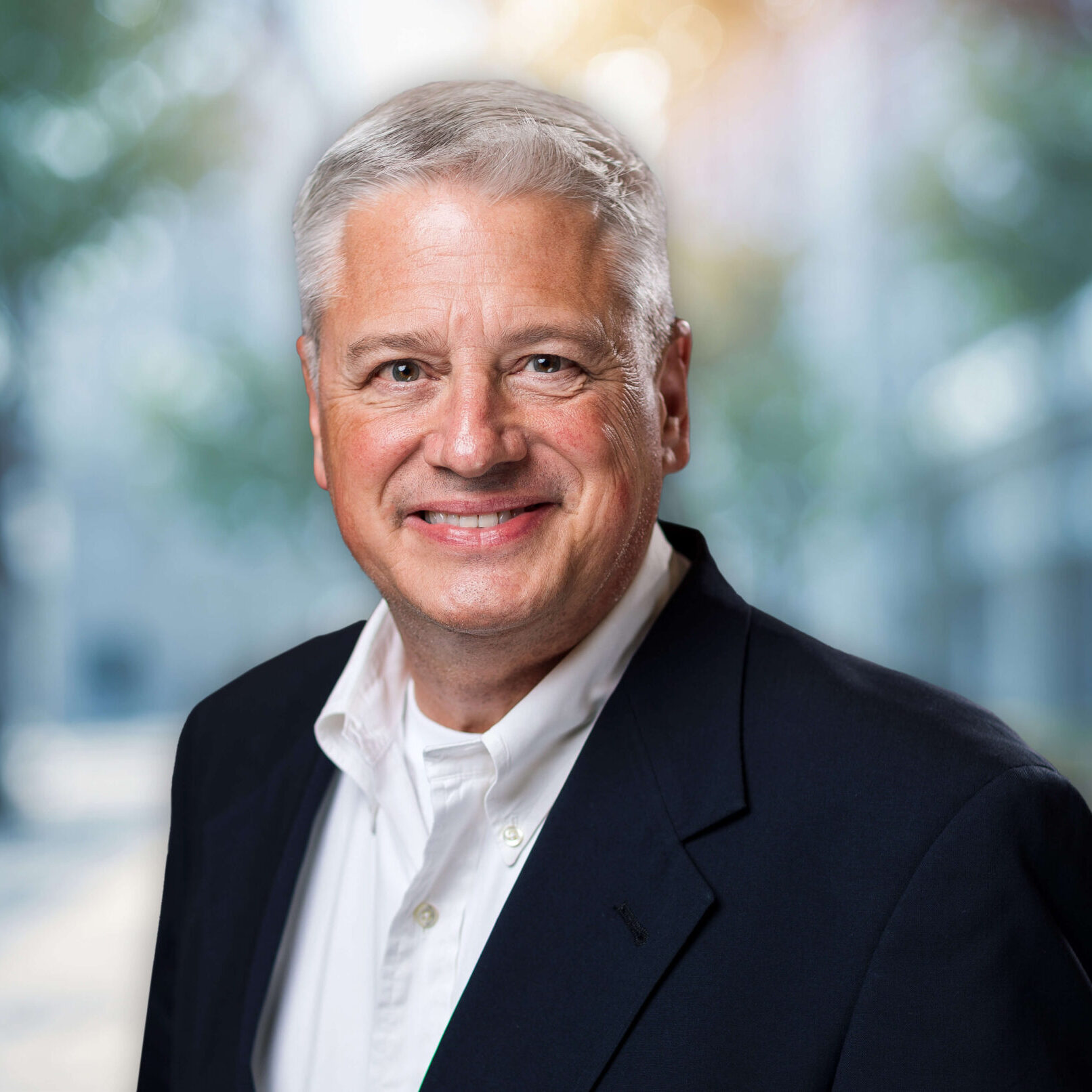 Smiling gray-haired man in business suit portrait