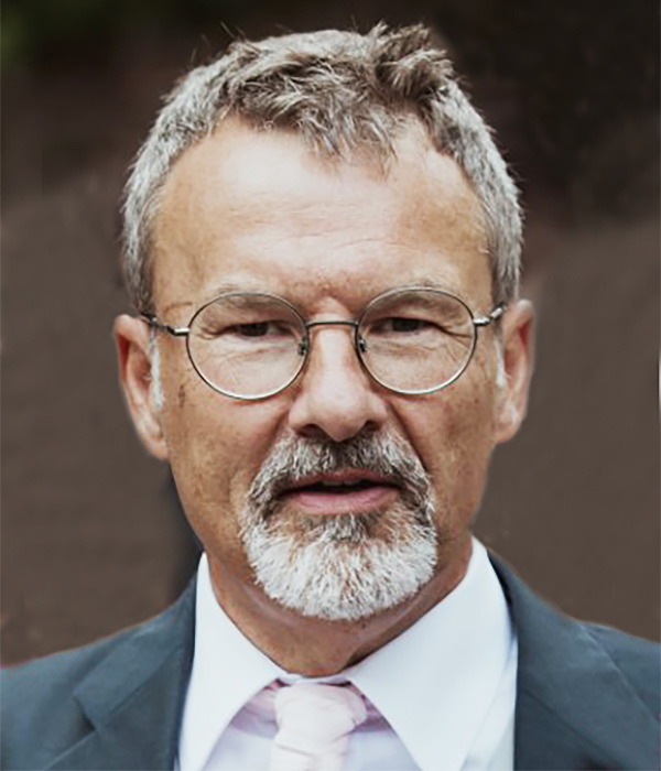 Man with glasses and beard in suit