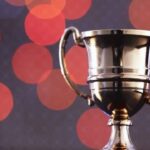 Silver trophy with bokeh lights background.