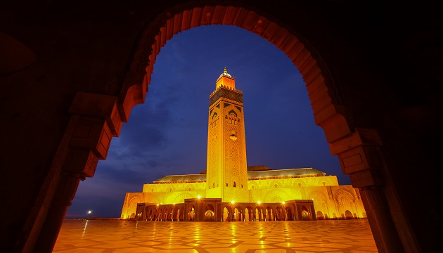 Illuminated mosque archway at night