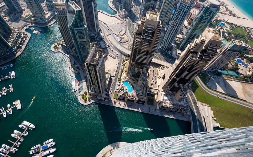 Aerial view of skyscrapers by waterfront.