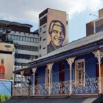 City buildings with colorful murals and advertisements.