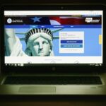 Laptop displaying ESTA application website.