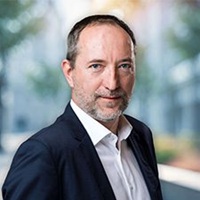 Professional headshot of man in suit jacket