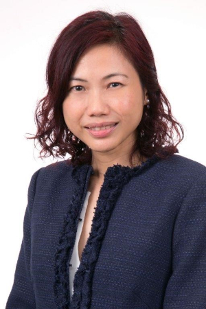 Woman smiling in professional attire.