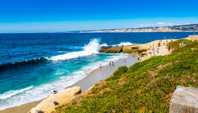 People enjoying a sunny day by the ocean