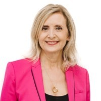 Smiling woman in a pink blazer