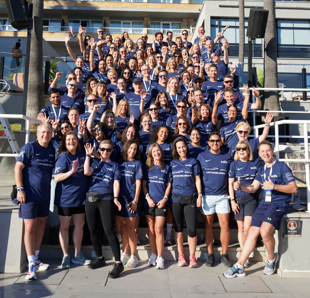 Group photo of people in blue shirts at event.