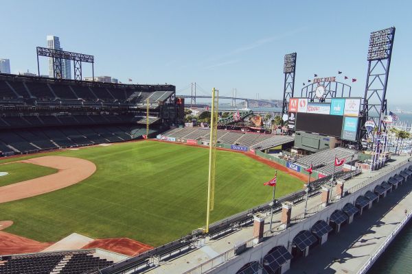 Baseball stadium overlooking waterfront with bridge in background