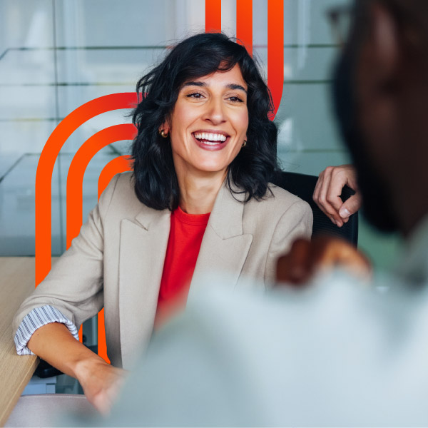 Smiling professional woman in office meeting
