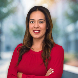 Woman in red top smiling outdoors