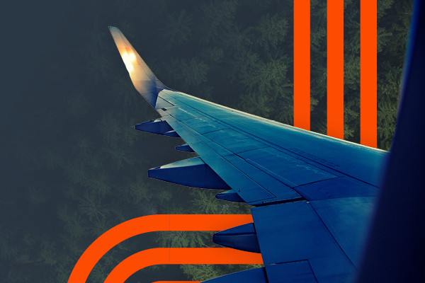 Airplane wing view with orange graphic overlay