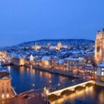 Zurich cityscape at dusk with illuminated buildings