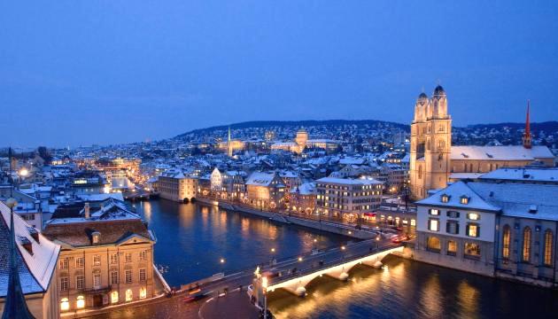 Zurich cityscape at dusk with illuminated buildings