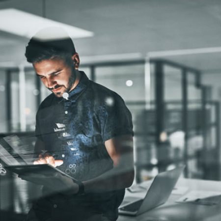 Man using transparent digital tablet in modern office