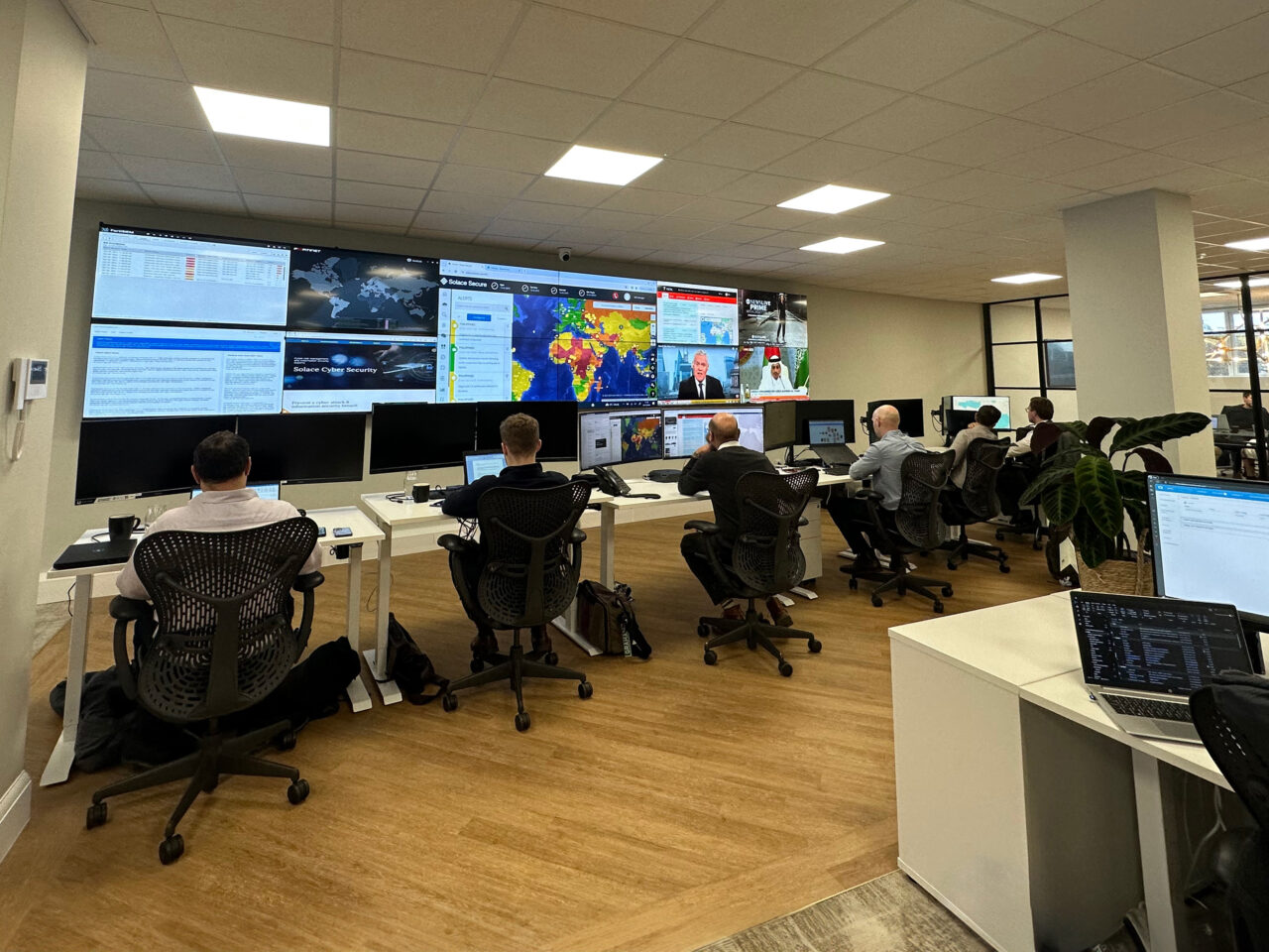 Cybersecurity operations center with analysts and large screens