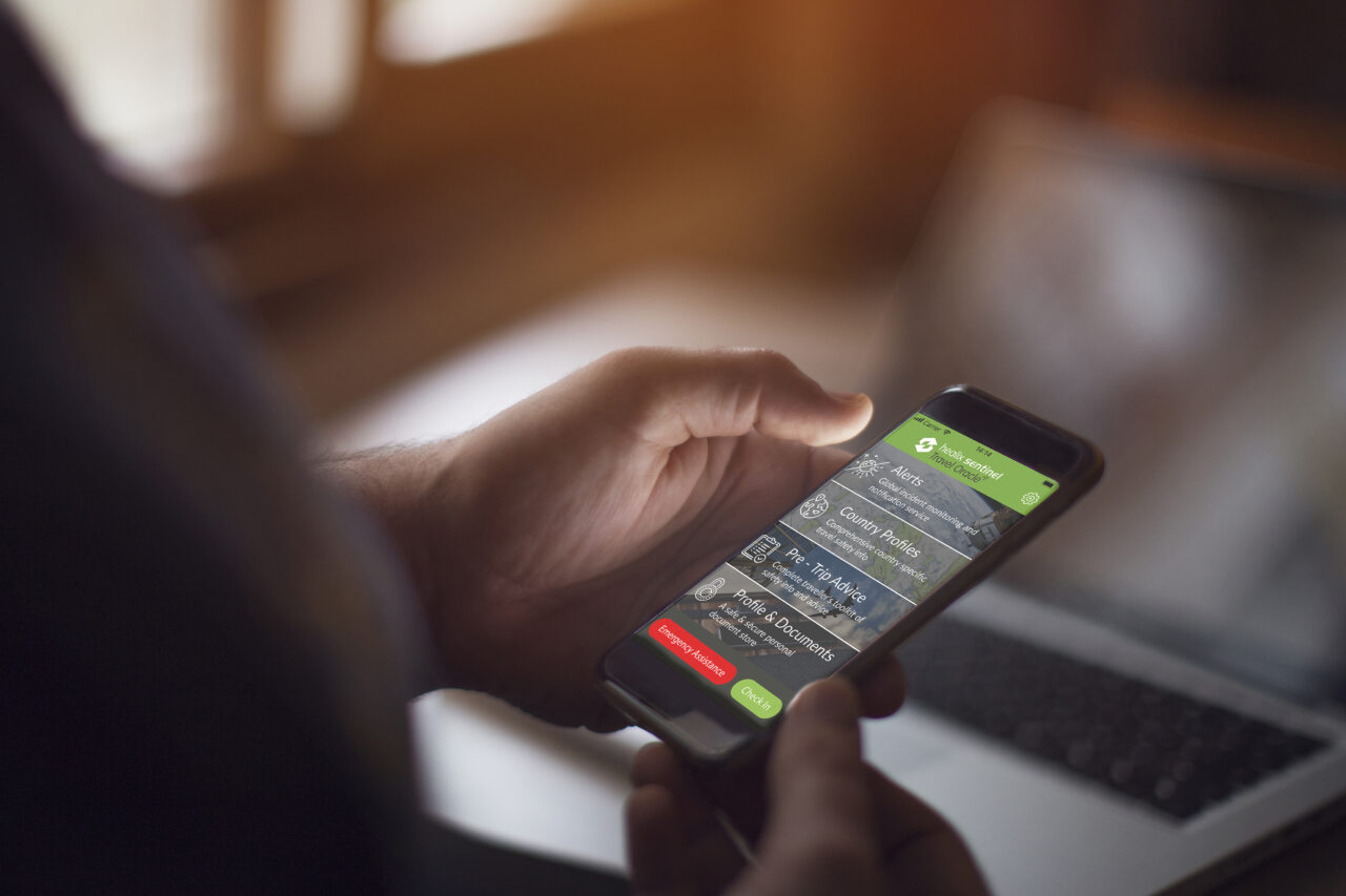 Person using travel safety app on smartphone