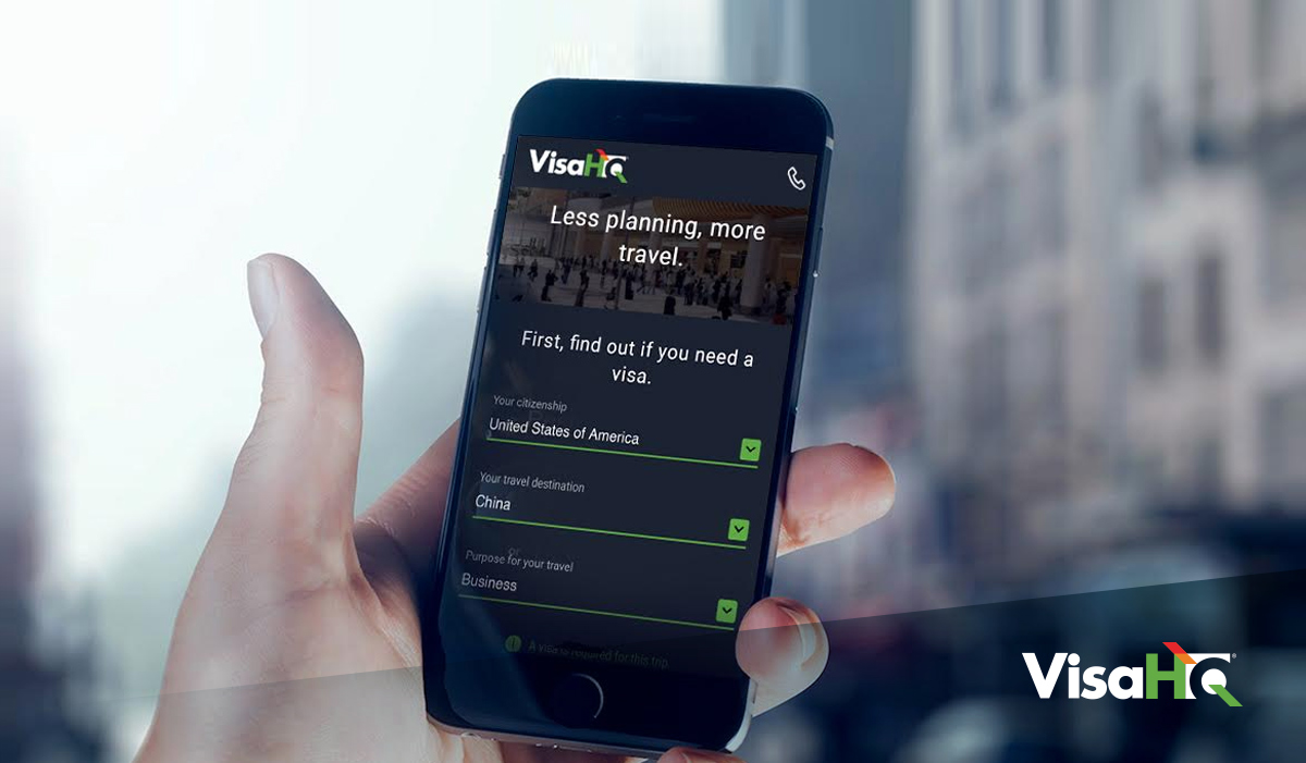 Hand holding smartphone with VisaHQ visa app