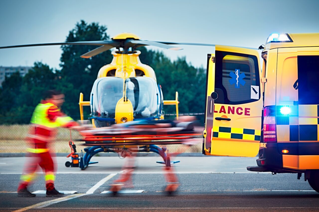 Paramedics loading patient into medical helicopter