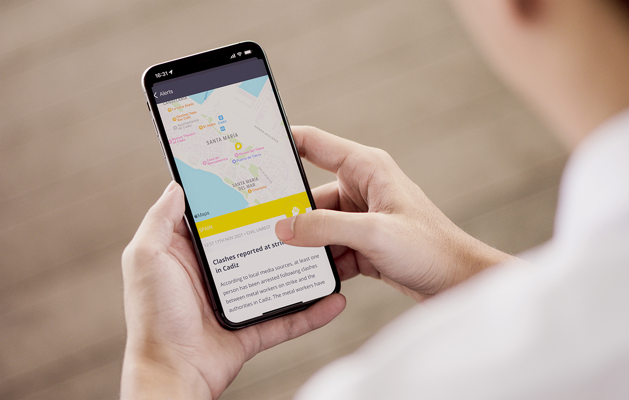 Person holding smartphone displaying map and news alert
