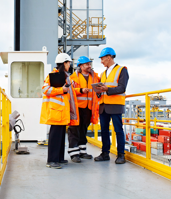 Construction workers discussing plans on site
